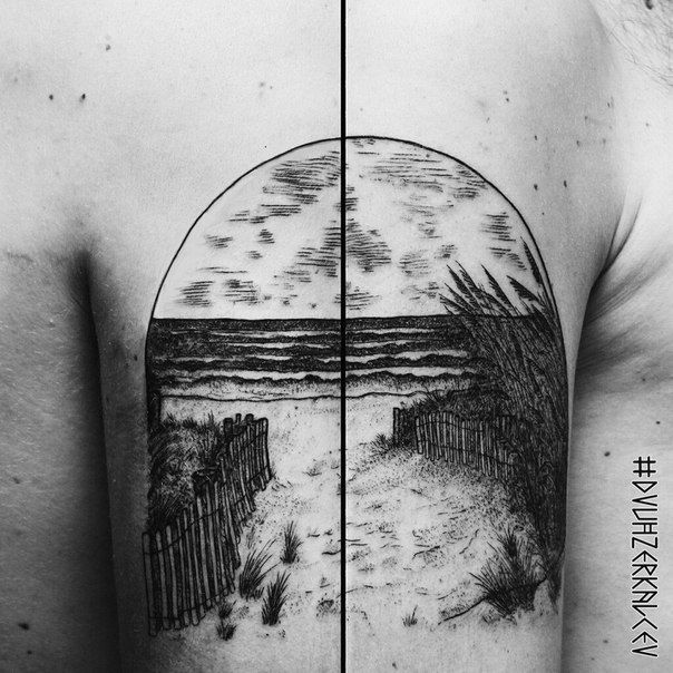 the back of a man's shoulder with a beach scene tattoo design on it