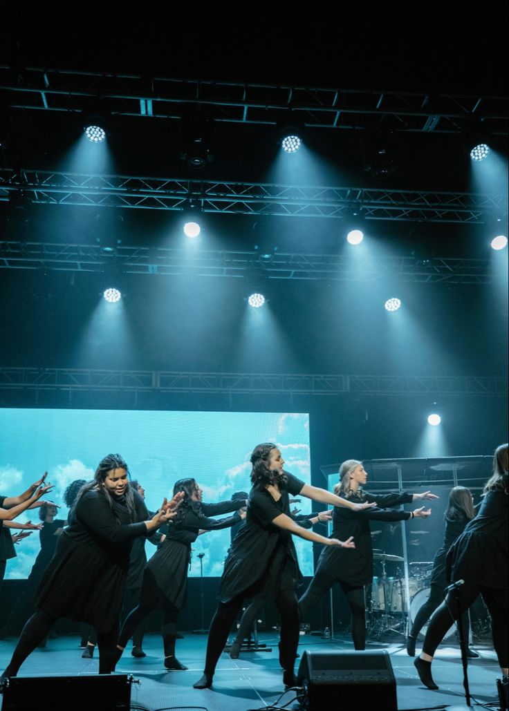 a group of people standing on top of a stage