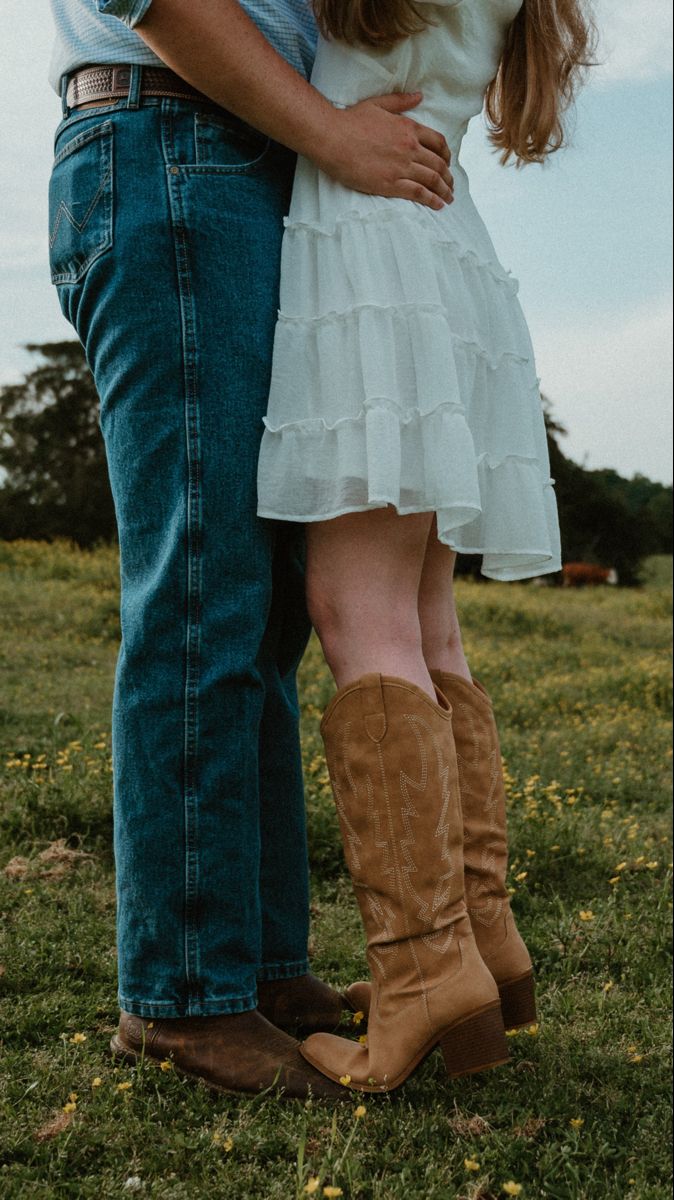 two people standing next to each other in the grass