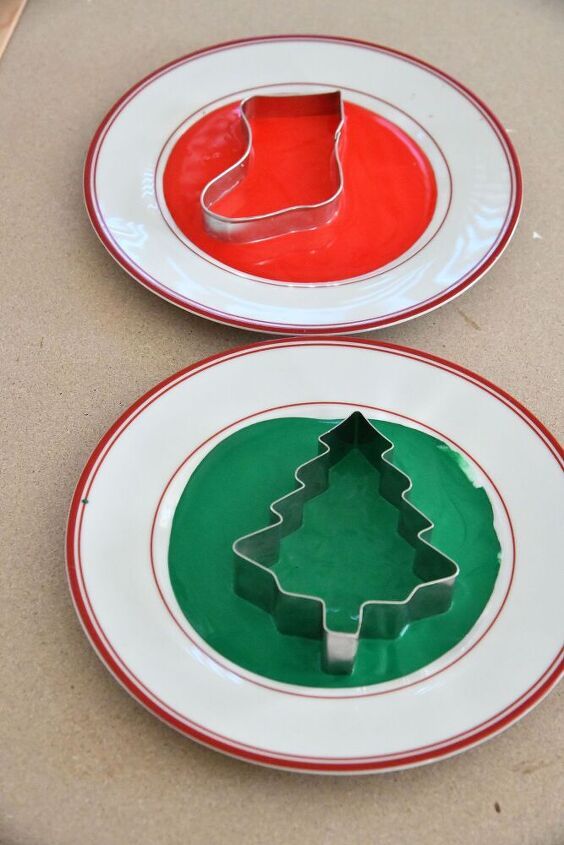 two plates with christmas tree cookie cutters on them