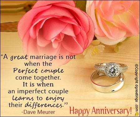 two wedding rings sitting on top of a table next to a pink rose and an anniversary card