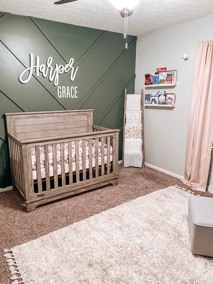 a baby's room with green walls and white carpet