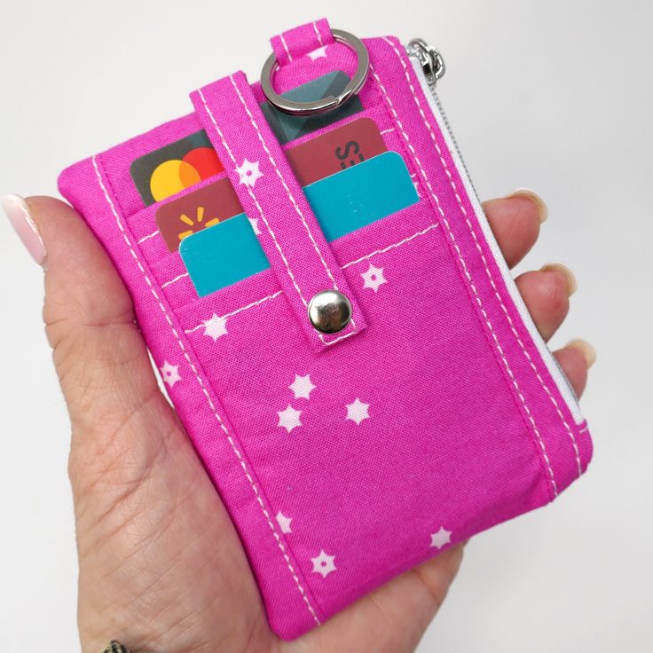 This hot pink with white stars Mini Card, Cash, and Coin Wallet features three dedicated card slots on the front secured with a snap tab, a clear pocket on the back also secured with a snap, perfect for ID, a scan card, showing off your kiddos [or grand kiddos etc., and a zippered pouch in between for stowing more cards, cash, or coins. This itty bitty wallet fits in the palm of your hand and right in your back pocket or just toss into your small or large bag!  Each dedicated card slot on the front easily accommodates 2 cards. Wallet, if used only as a card wallet, holds about 15 cards.  📬 READY TO SHIP 📝 ITEM FEATURES 📝 📏 Wallet Measures: 4.75" wide by 3.5" tall 3 Credit Card Slots   1 Clear ID Pocket Zippered Pouch 1 Split Ring   100% Cotton  MORE HERE WE GO MINI WALLETS: https://www Pocket Wallet, Coin Wallet, Mini Wallet, Pink Mini, Minimalist Wallet, Clip Wallet, Credit Card Holder, Large Bag, Money Clip Wallet