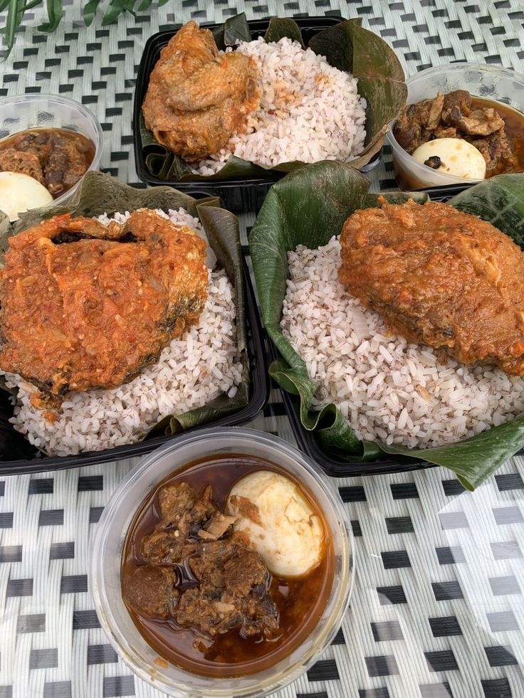 several plates of food on a table with rice, meat and sauces in them