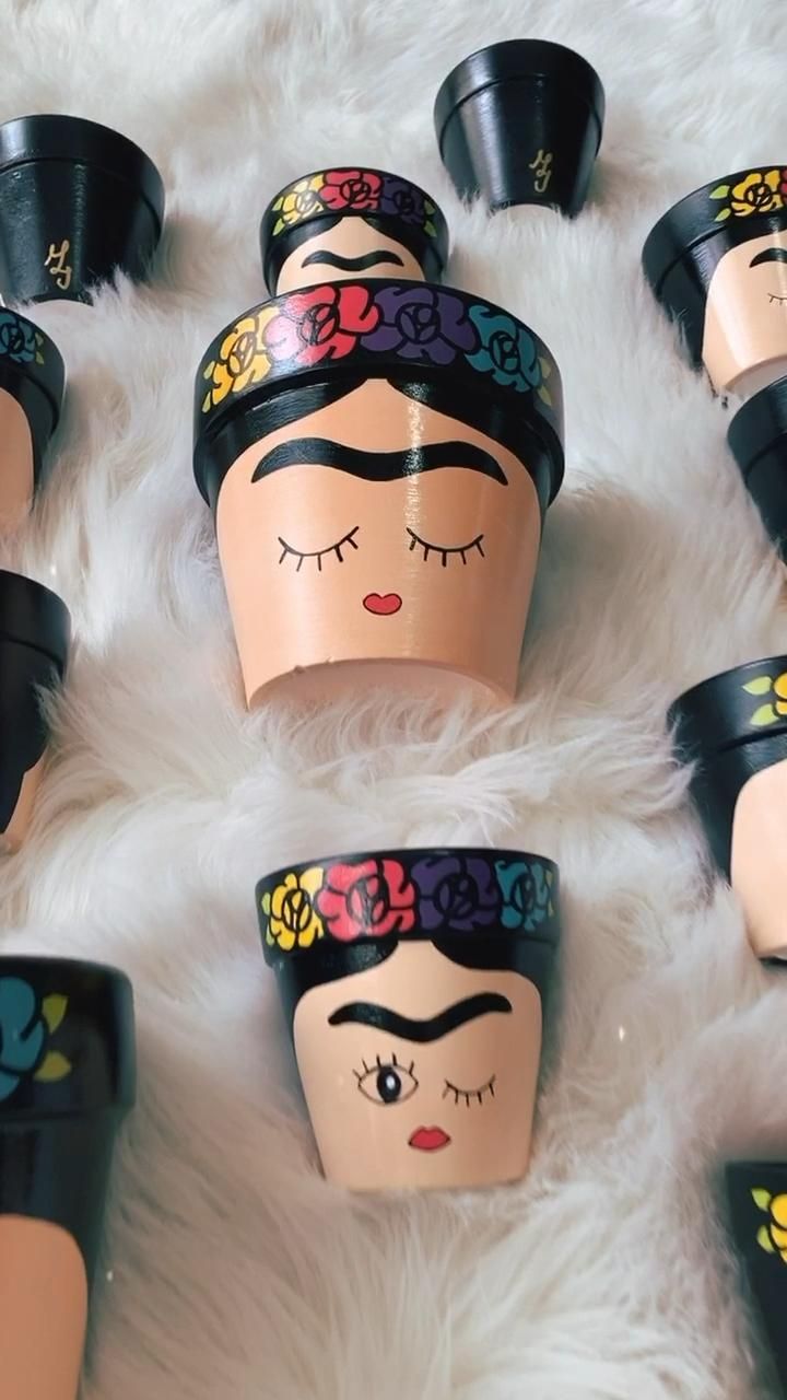 many different types of plastic cups with faces painted on them