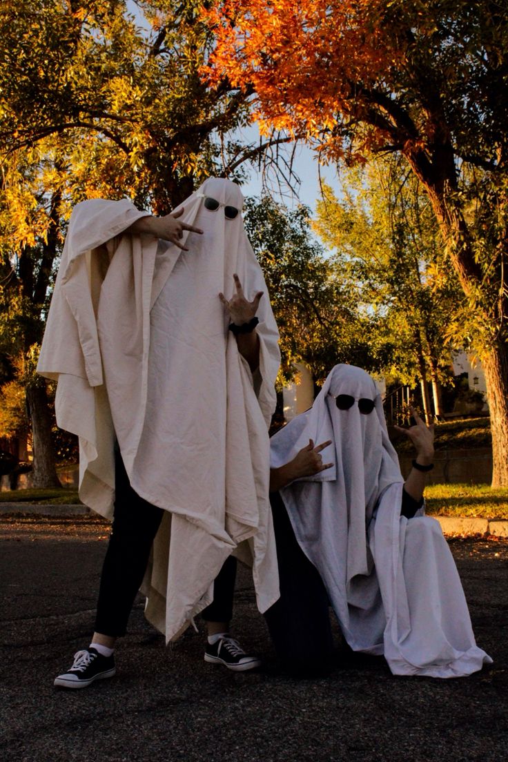 two people dressed in white and black clothing