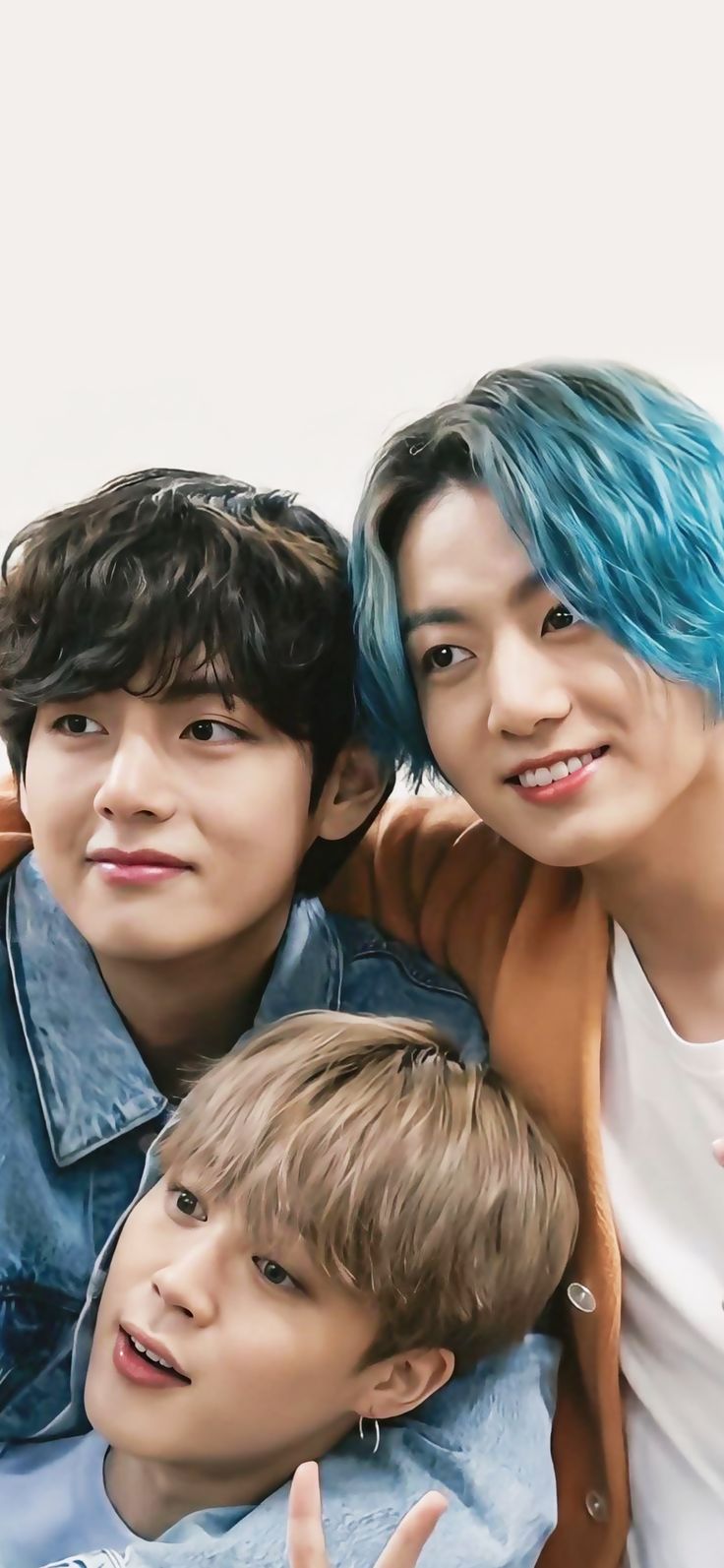 three boys with blue hair posing for the camera