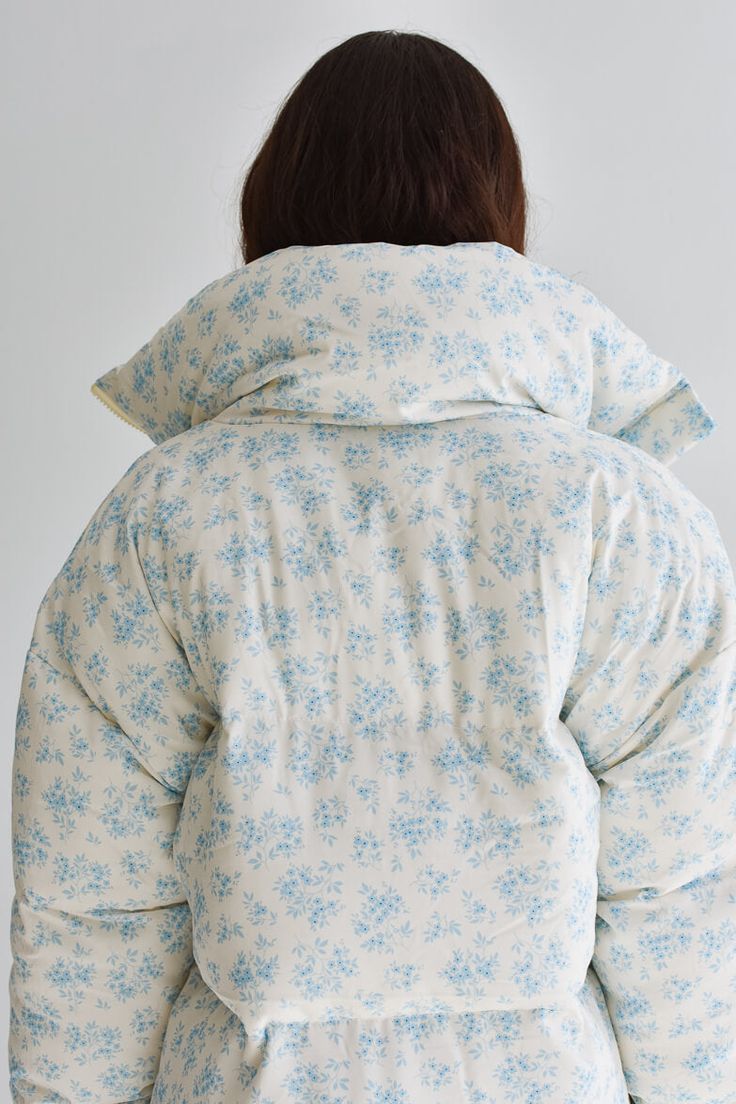 This bestseller is back in stock! Stay warm and stylish in our Lark Floral Puffer Jacket! This is a customer must-have from market this year. With its cozy and trendy design featuring a cream and blue floral print fabric, zipper front, and playful bow details, this jacket is the perfect addition to your wardrobe. Plus, it has pockets for added convenience. Winter just got a whole lot cuter! Hits at the hip. FIT: Fits true to size. We recommend taking your normal size, and you can still wear with Spring Cotton Puffer Jacket For Cold Weather, Cotton Puffer Jacket For Spring Cold Weather, Cotton Puffer Jacket With Padded Collar, Spring Cotton Quilted Jacket For Cold Weather, Spring Long Sleeve Puffer Quilted Jacket, Spring Hooded Quilted Jacket With Padded Collar, Long Sleeve Puffer Quilted Jacket For Spring, Hooded Quilted Jacket With Padded Collar For Spring, Fitted Quilted Jacket With Padded Collar For Spring