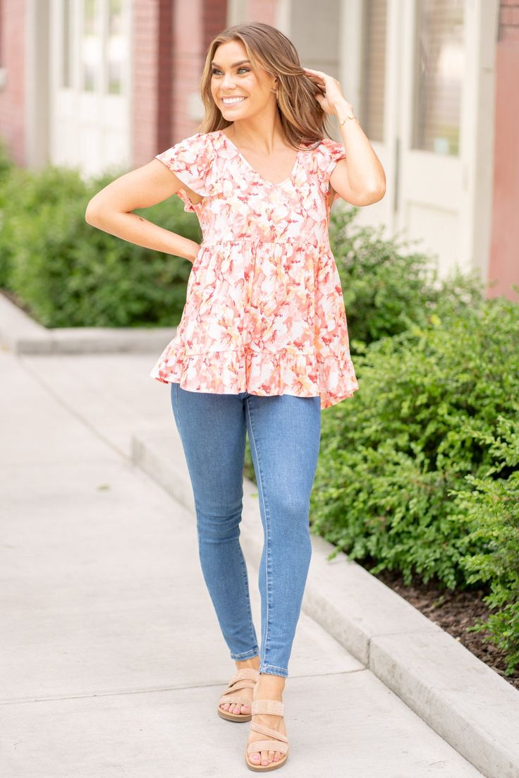 The Floral Ruffled Babydoll Top is a flirty and feminine addition to your wardrobe. The floral print adds a charming and romantic touch to the top. The ruffled detailing enhances the playful and girly vibes of the design. Pair this top with jeans or a skirt for a sweet and stylish outfit. Made from soft and lightweight fabric, this top is perfect for the warmer weather. Embrace your feminine side and turn heads in this delightful Floral Ruffled Babydoll Top that exudes effortless chicness! Featu Feminine Ruffle T-shirt For Spring, Spring Ruffle Button-up Tops, Feminine Ruffled Tops With 3/4 Sleeves, Casual Pink Ruffled T-shirt, Top With Jeans, Baby Doll Top, Pink Ruffle Sleeve T-shirt With Ruffles, Girly Vibes, Jean Overalls