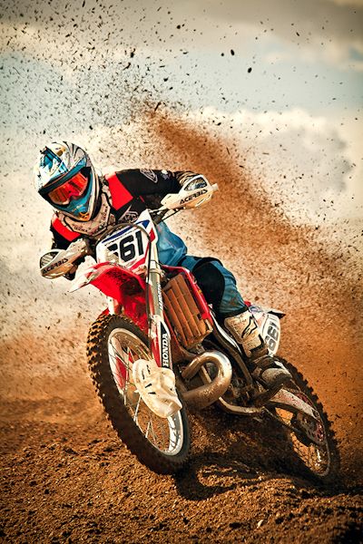 a man riding on the back of a dirt bike