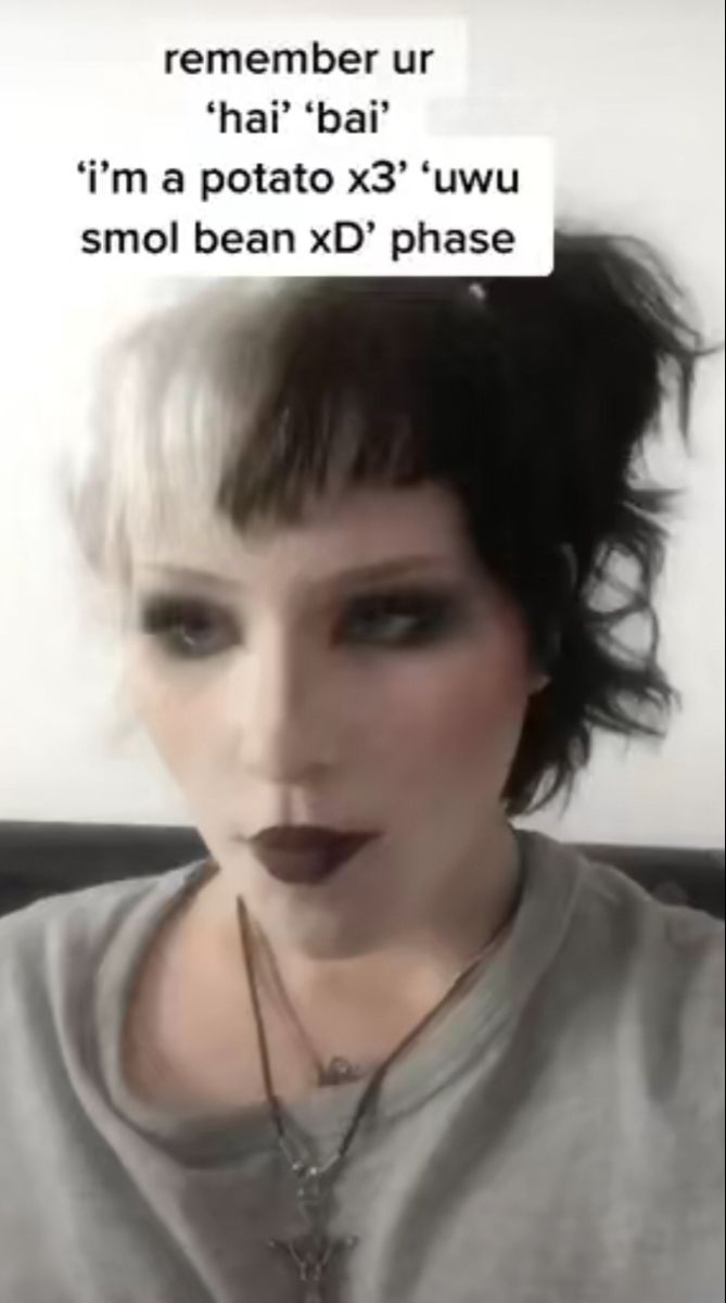 a woman with short hair and black lipstick