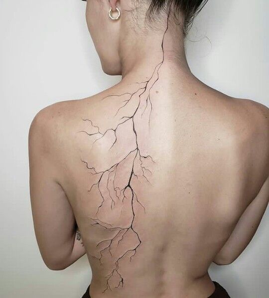 the back of a woman's neck with a lightning bolt on it