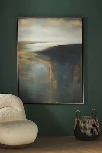 an abstract painting hangs on the wall next to a chair and vase in front of it