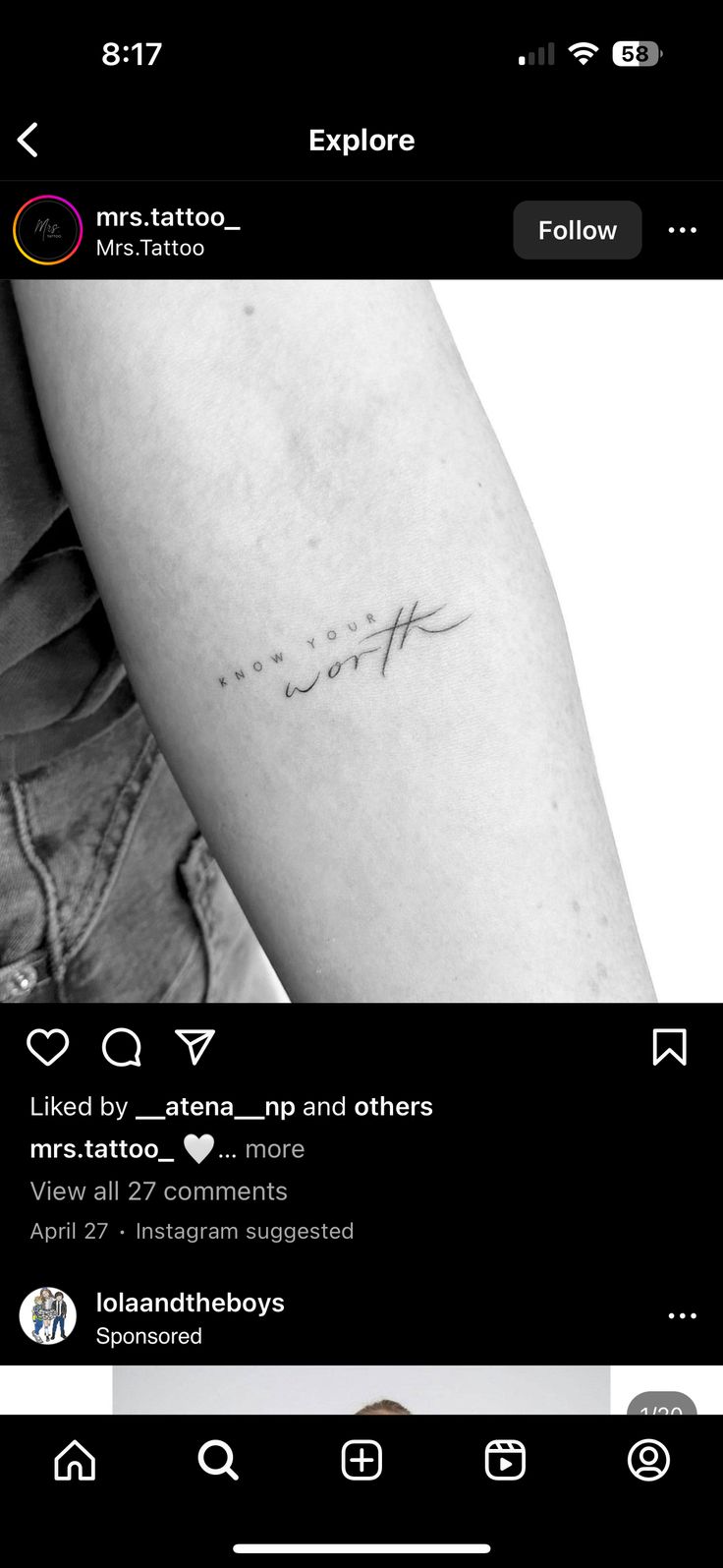 the back of a person's arm with a small tattoo on it, which reads love