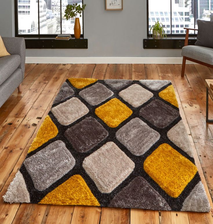 a living room filled with furniture and a rug on top of a hard wood floor