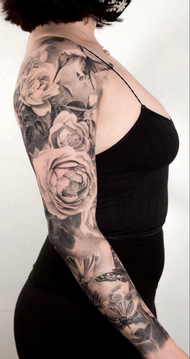 a woman with tattoos on her arm and shoulder