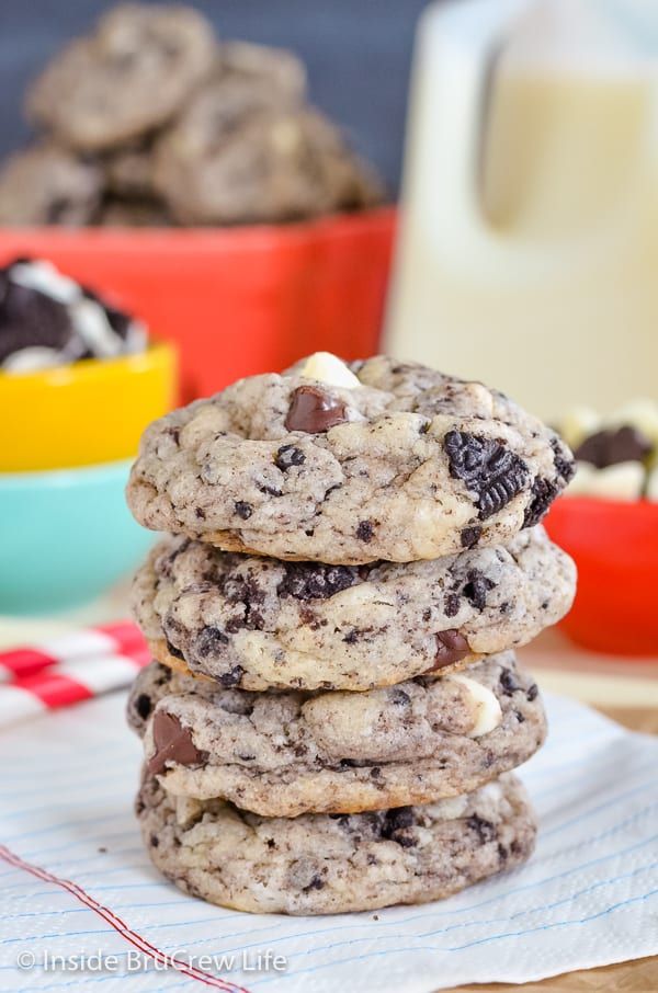 a stack of cookies with chocolate chips and marshmallows in the middle on a table