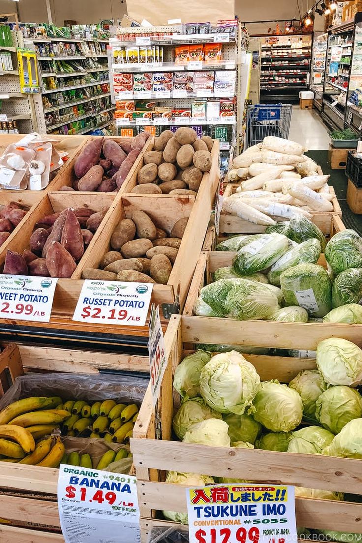 an assortment of vegetables are on display in the produce section of a grocery store for sale