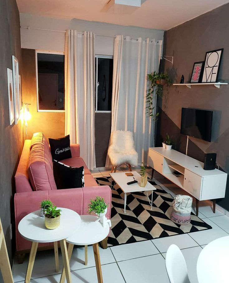 a living room filled with furniture and a flat screen tv sitting on top of a white table