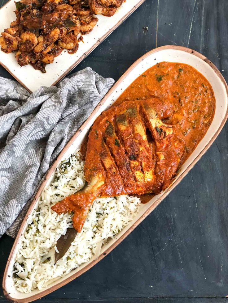 two plates filled with chicken and rice on top of a table