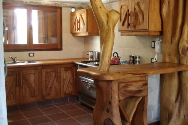 a kitchen with wooden cabinets and tile flooring