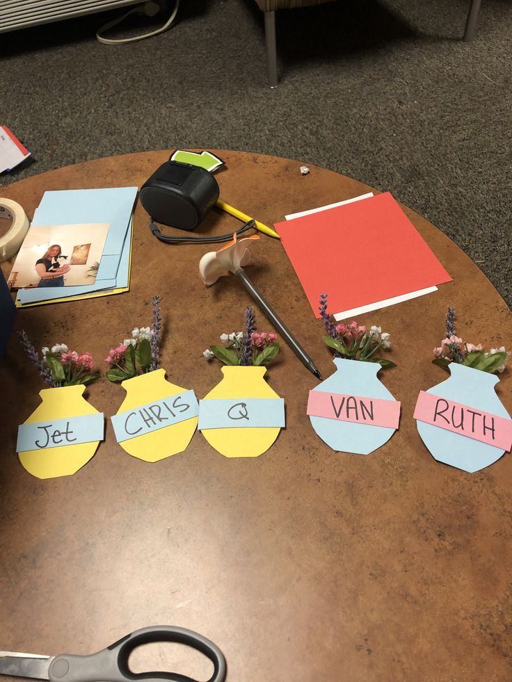 a table topped with lots of different types of paper and crafting supplies on top of it