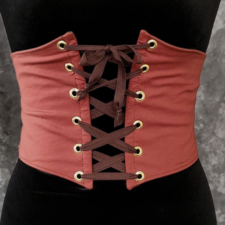 "This waist cincher is made in 100% Cotton in BURNT ORANGE. The perfect compliment to your Witch, Pirate, Renaissance, Medieval or other fantasy cosplay costume. It is lined with cotton duck and it has spring steel boning in the front for stability and to reinforce the grommets (this boning has some flex to it so it will move with you some as well). A very comfortable, yet sturdy piece.   Measure your waist as the smallest point (typically just about the belly button) and choose from the following sizes:  X-SMALL: Waist 25.5 - 28 inches (64 - 71 cm) SMALL: Waist 28 - 31 inches (71 - 79 cm)  MEDIUM: Waist: 30 - 33 inches (76 - 84 cm) LARGE: Waist: 32 - 35 inches (81 - 89 cm) X-LARGE: Waist: 34 - 37 inches (86.5 - 94 cm)  XXLARGE: Waist 36 - 39 inches (91.5 - 99 cm) ✿✿THIS PIECE IS MADE TO O Punk Corset For Halloween Larp, Gothic Corset Belt For Festivals, Overbust Corset Belt For Halloween Cosplay, Steampunk Fitted Corset Belt For Festivals, Steampunk Corset Belt For Halloween Costume Party, Steampunk Corset Belt For Larp And Halloween, Steampunk Corset For Larp And Cosplay Events, Fitted Punk Corset Belt For Cosplay, Punk Style Fitted Corset Belt For Cosplay