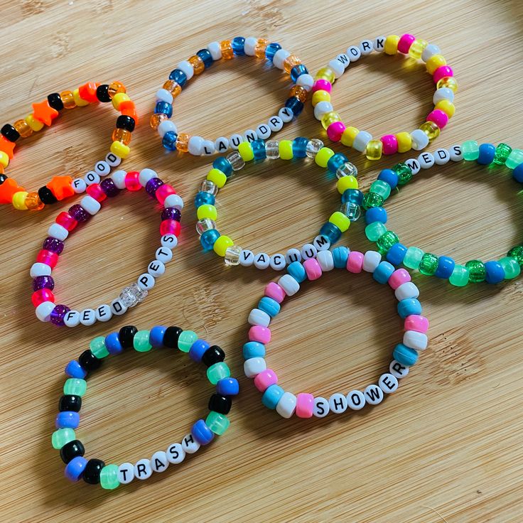 CUSTOM MADE kandi reminder/tracker bracelets: perfect for those of us with disabilities, kids, neurodivergent people, and anyone who may tend to forget chores! How it works: When you notice a task that needs doing, put on the corresponding bracelet. After it's finished, take it off! It's that simple! These single bracelets are handmade using plastic pony beads and elastic string. Each set of bracelets is custom made to fit your specific needs and preferences. To order, please let me know the wording for your bracelets (please note that longer words/phrases will be shortened to preserve space if you have any color or bead preferences, and the size of your wrist. Example Tasks: Shower, laundry, work, school, trash, feed pets, medicine/meds, dishes... just let me know what you need! If you ha Chore Bracelet, Plastic Beads Bracelets, Task Bracelets, Word Bracelet Beads Ideas Funny, Kandi Words, Kandi Phrases, Reminder Bracelets, Kandi Creations, Chore Tracker