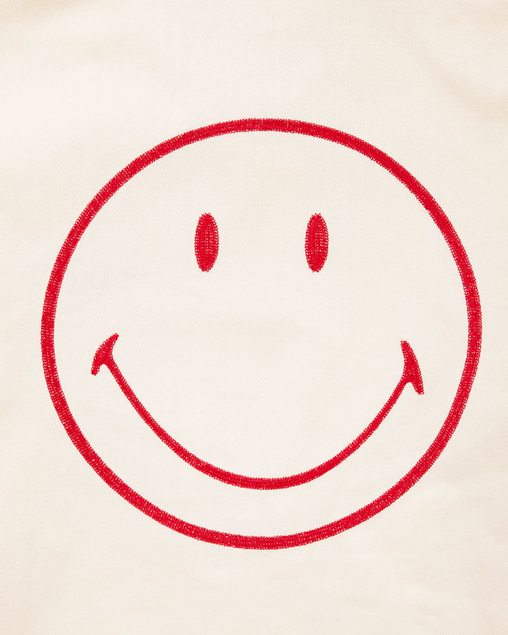 a white t - shirt with a red smiley face drawn on it