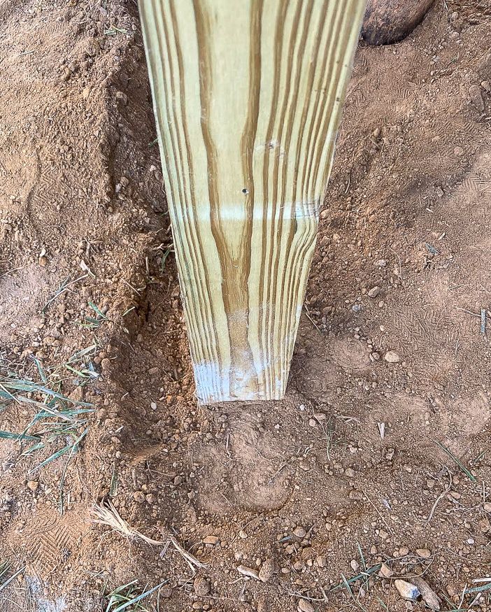 a close up of a wooden object in the dirt