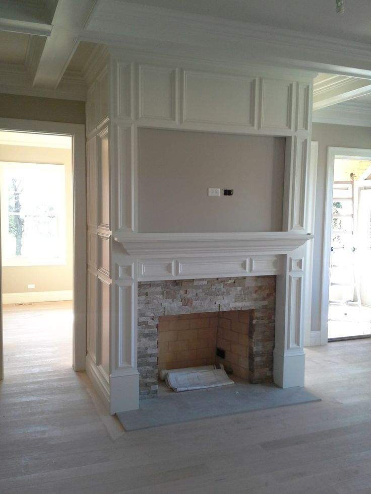 an empty living room with a fireplace in it