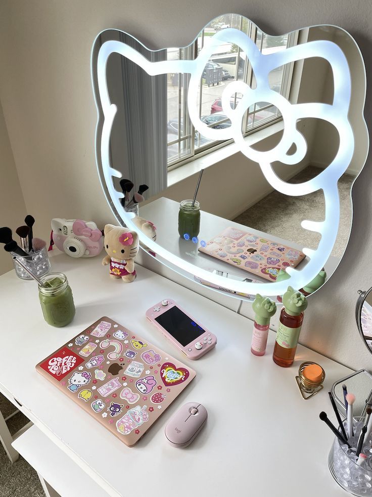 a desk with a mirror, cell phone and other items on it