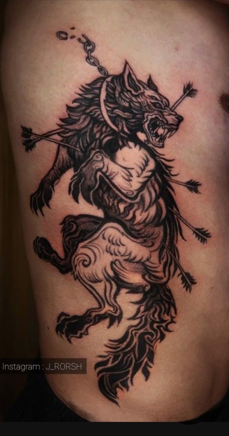 a black and white tattoo on the side of a woman's stomach, with a dragon