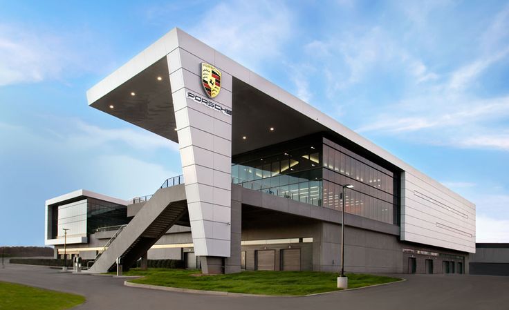 a large modern building with stairs leading up to it's top floor and windows