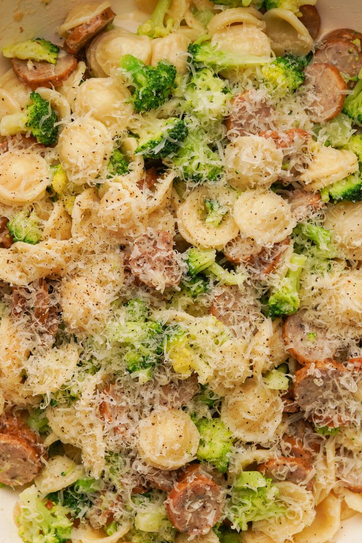 pasta with sausage, broccoli and mushrooms in a white casserole dish