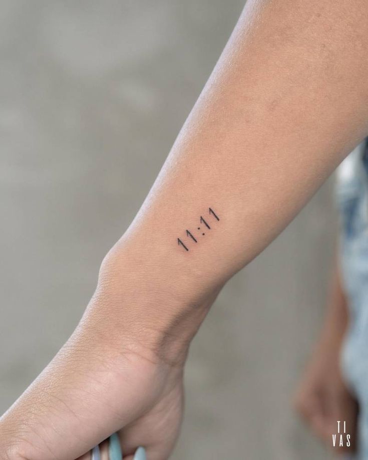 a person's arm with the word faith tattooed on it, in black ink