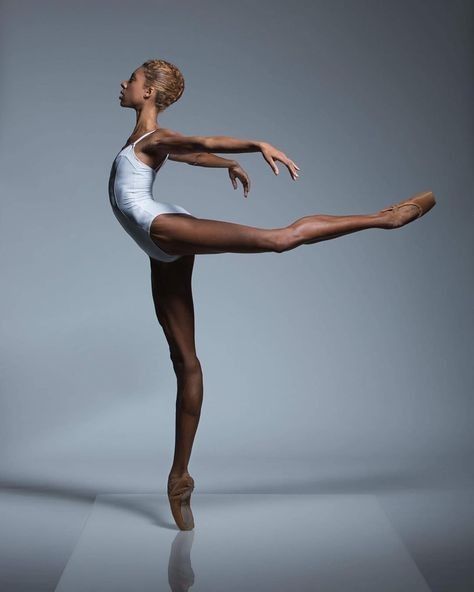 a woman in white leotard doing a ballet pose