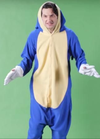 a man in a blue and yellow animal costume is standing with his hands out to the side