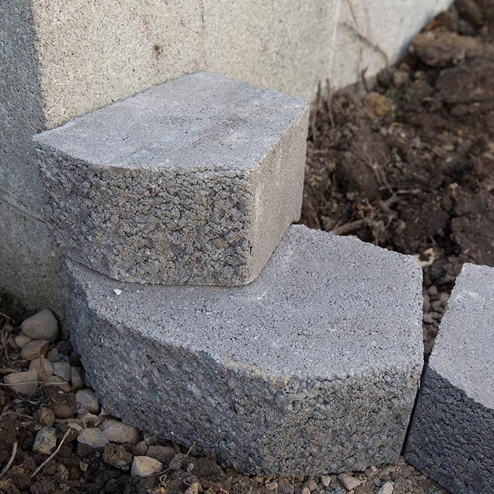 two cement blocks sitting next to each other on the ground