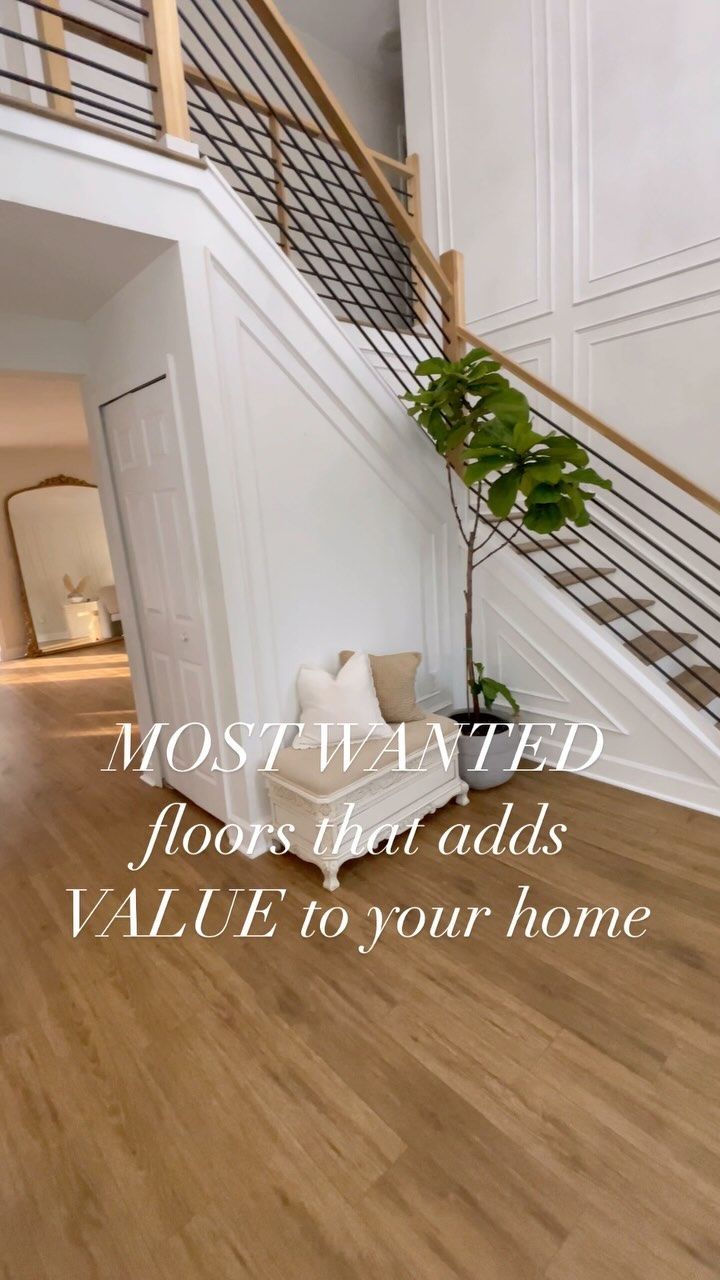 the stairs in this house have been painted white and there is a potted plant next to it