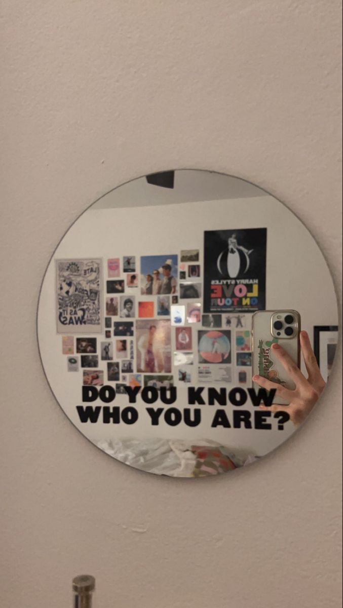 a round mirror with the words do you know who you are?