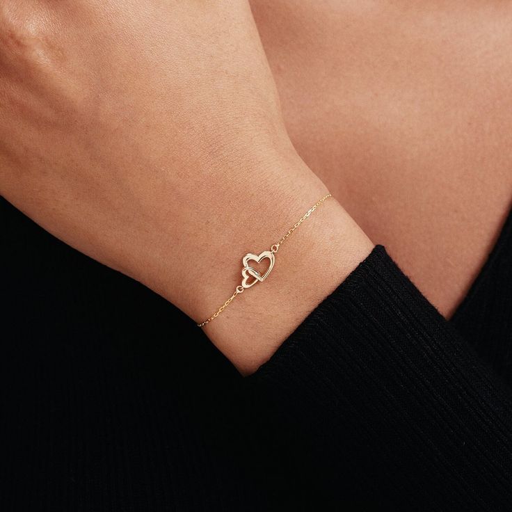 "1- P R O D U C T ∙  D E S C R I P T I O N Showcase your love with our Interlocking Heart Bracelet in 14K Solid Gold. Perfect as a couple bracelet or a stunning gift for her, this double heart bracelet captures the essence of romance. Crafted from 14k solid gold, it adds a touch of luxury to any outfit. This 14k gold jewelry is not just a purchase, but an investment in timeless style. 2- P R O D U C T ∙  D E T A I L S Gold material: 14K solid gold Choice of gold color: Yellow gold, Rose gold, White gold Choice of chain length: 5\", 5.5\", 6\", 6.5\", 7\" +1\" Extender Dimensions: * Height: 9 mm /  0.35 in * Width: 12 mm /  0.47 in 3- S H I P P I N G ∙ A N D ∙ R E T U R N S We know you're excited to get your hands on your order, and we're just as excited to get it in your hands. We take pri Elegant Rose Gold Heart Cut Bracelet, Elegant Heart Cut Bracelet As A Gift, Elegant Heart Cut Bracelet Perfect As A Gift, Elegant Heart-shaped Diamond Bracelet For Valentine's Day, Elegant Heart-shaped Diamond Bracelet As Gift, Elegant Heart Shaped Diamond Bracelet For Gift, Elegant Heart-shaped Diamond Bracelet For Gift, Elegant Heart-shaped Diamond Bracelet Gift, Fine Jewelry Heart Charm Bracelet For Anniversary