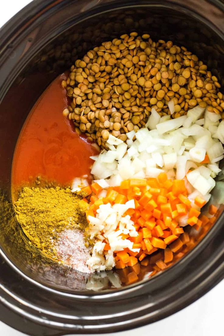 the ingredients are in the slow cooker to make this meal, including carrots and lentils