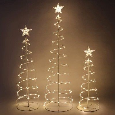 three christmas trees with lights in the shape of stars