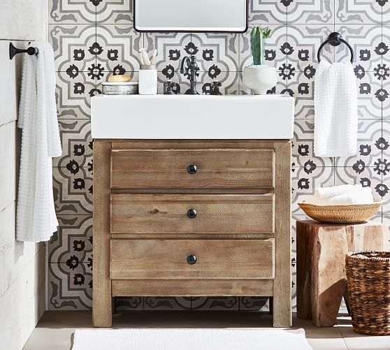 a bathroom with a sink, mirror and towel rack on the wall next to it