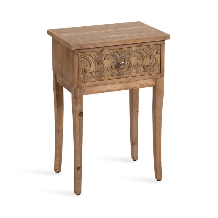 a wooden table with an ornate design on the top and drawer at the bottom, against a white background