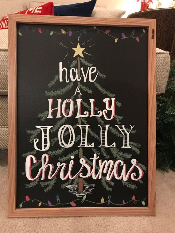 a chalkboard sign that says have a holly jolly christmas