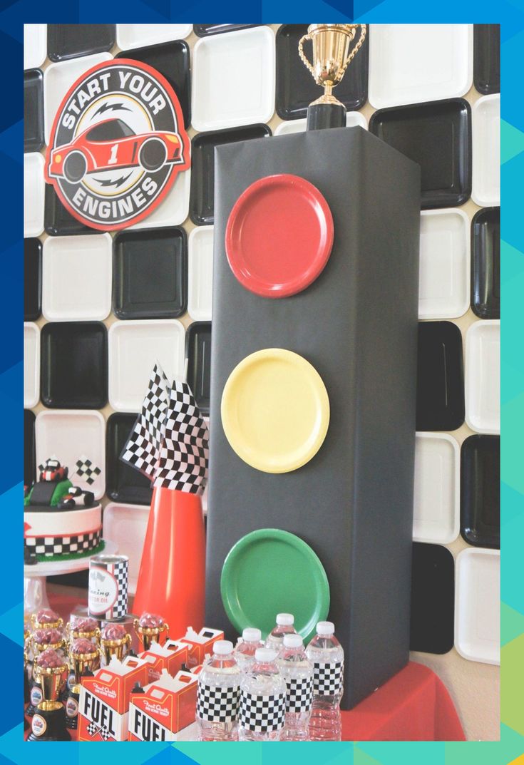 a table topped with plates and cups next to a traffic signal sign on top of a counter