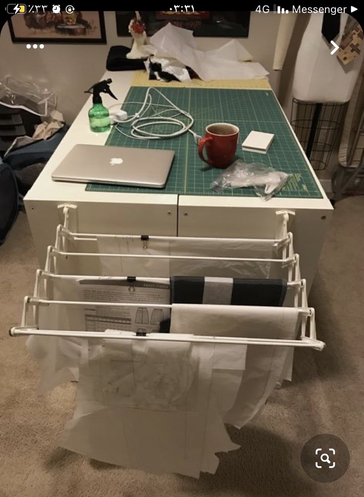 a laptop computer sitting on top of a table next to a pile of paper towels