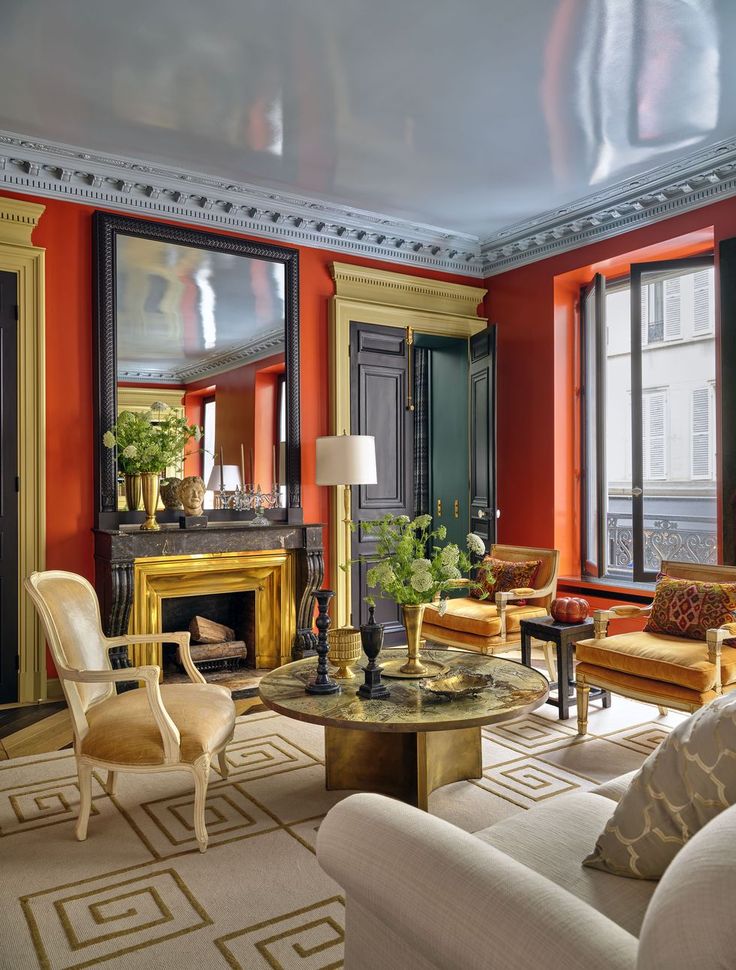 a living room filled with furniture and a fire place in the middle of a room